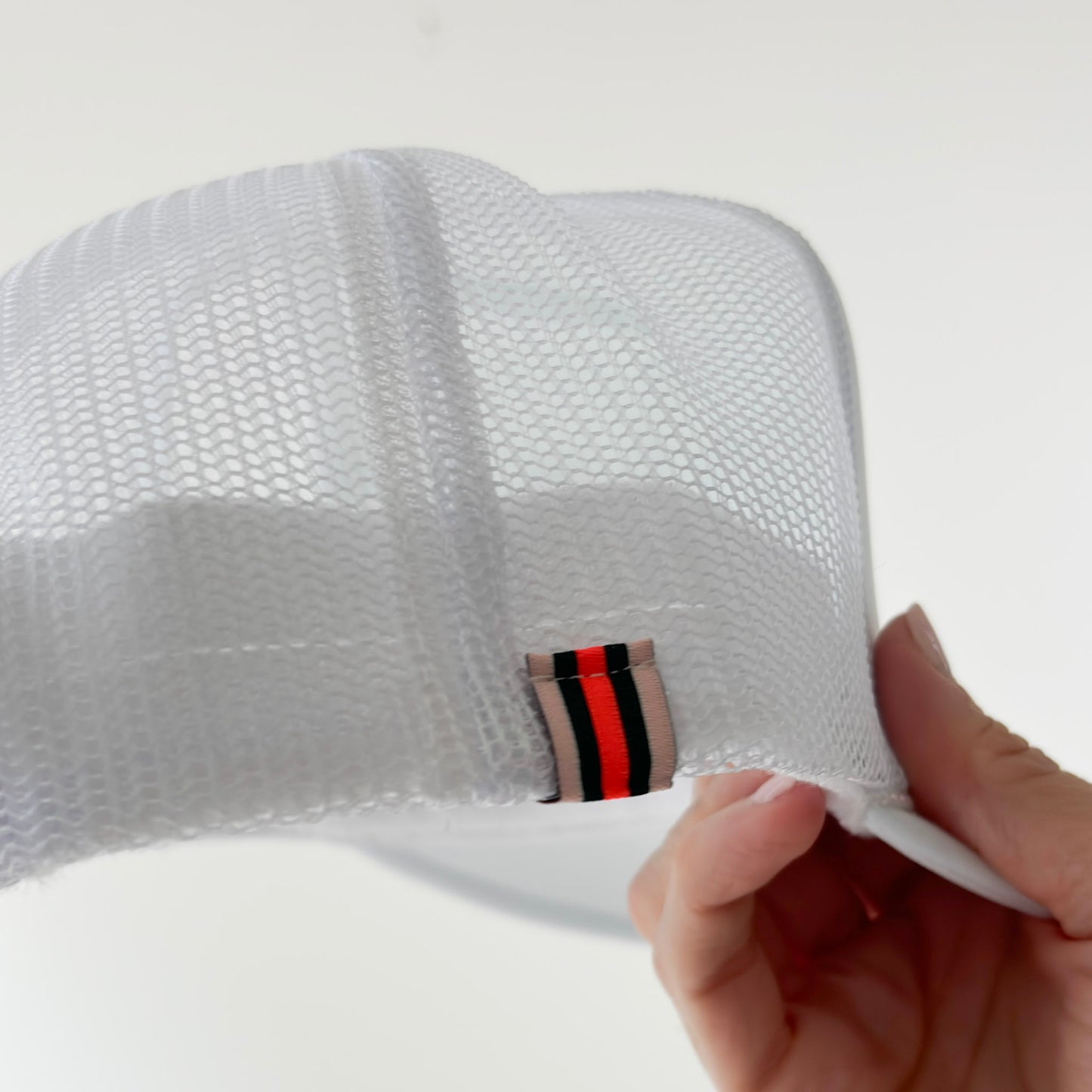 Women's white high profile foam snap back trucker hat with navy blue take me to the lake graphic