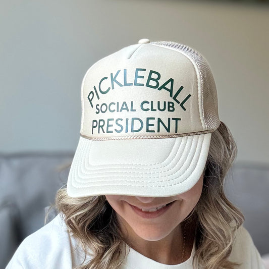 Tan mid profile trucker hat with dark green pickleball social club president print