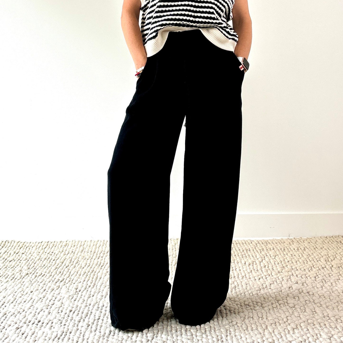 Women's black smocked waist wide leg pant with pockets and tassel drawcord