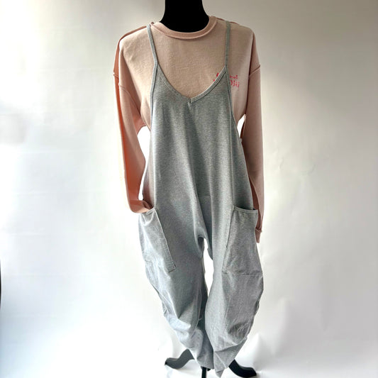 Soft knit grey jumpsuit with racer back, front pockets and neon coral heart embroidery