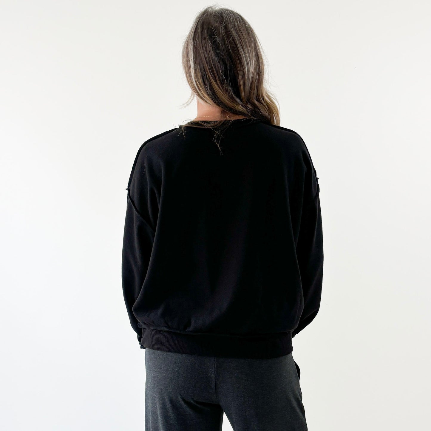 Women's black inside out fuzzy fleece sweatshirt with exposed seems and prosecco please print