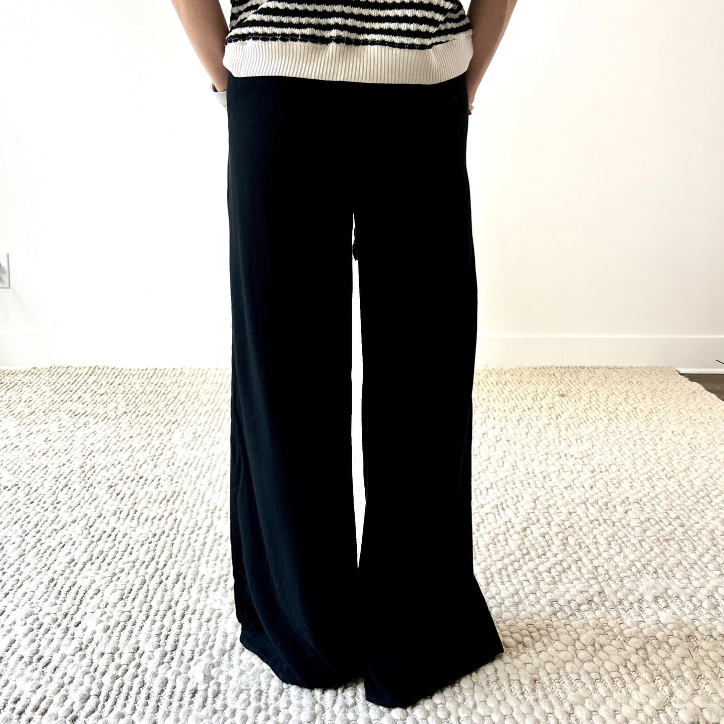 Women's black smocked waist wide leg pant with pockets and tassel drawcord