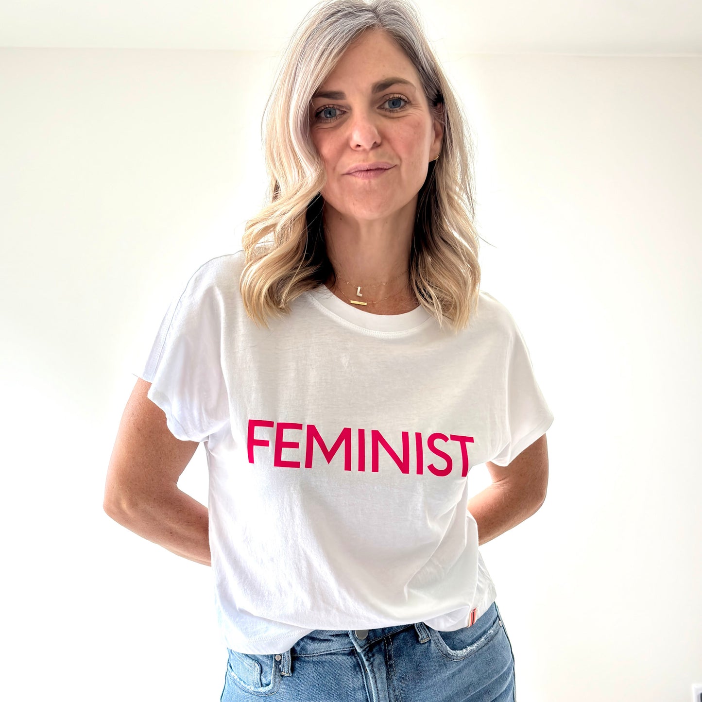 women's white short sleeve t shirt with neon pink feminist print