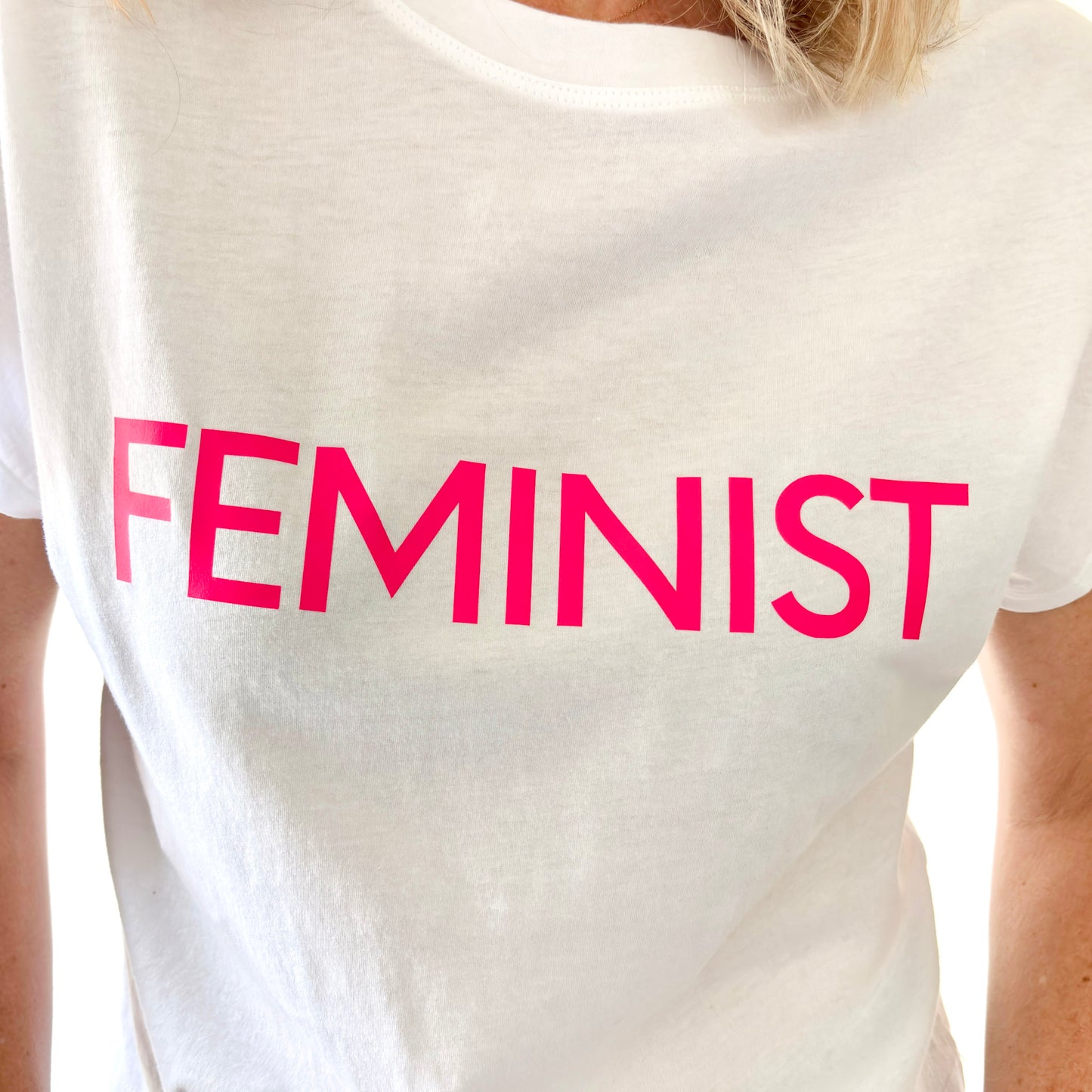 women's white short sleeve t shirt with neon pink feminist print