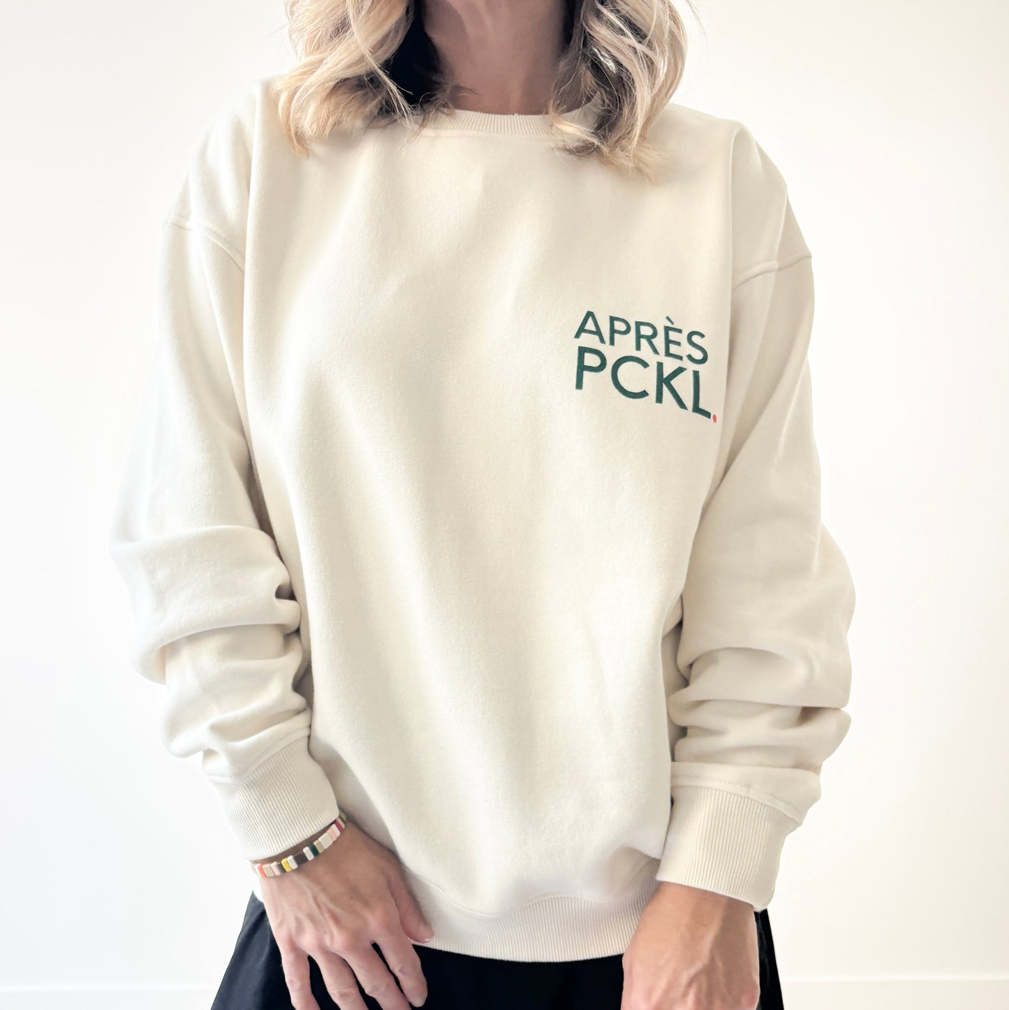 Ivory crew neck fleece sweatshirt with dark green après pckl. pickleball chest print