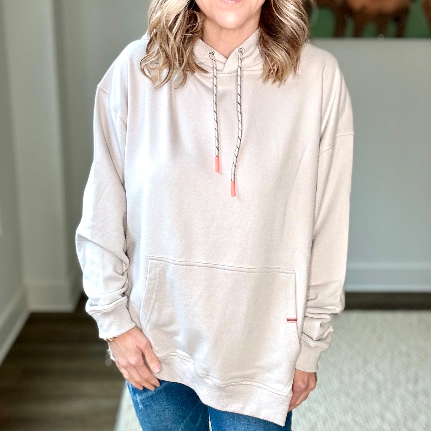 Light grey super soft hooded side zip pullover sweatshirt with front pocket and neon coral tipped drawcord Edit alt text