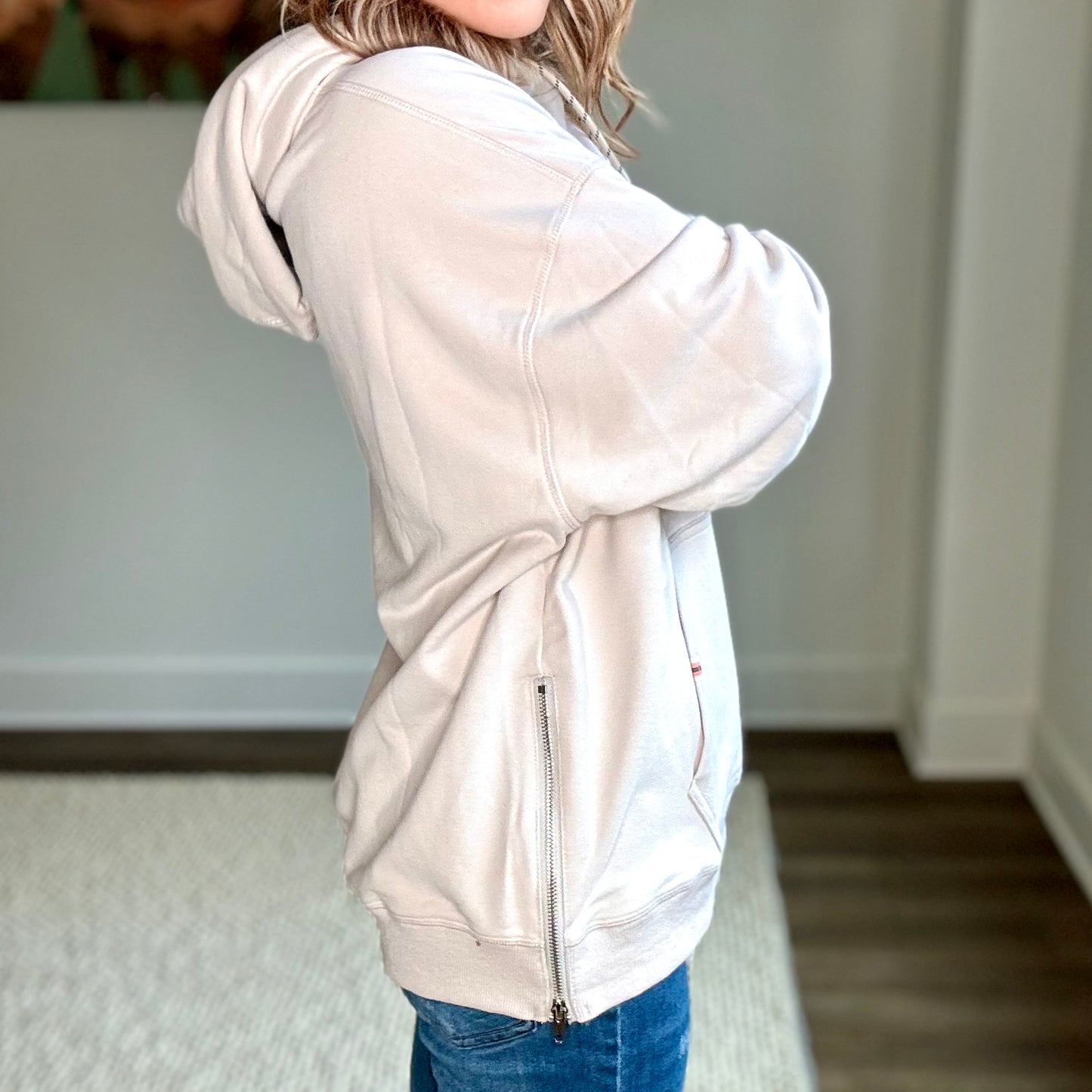 Light grey super soft hooded side zip pullover sweatshirt with front pocket and neon coral tipped drawcord Edit alt text