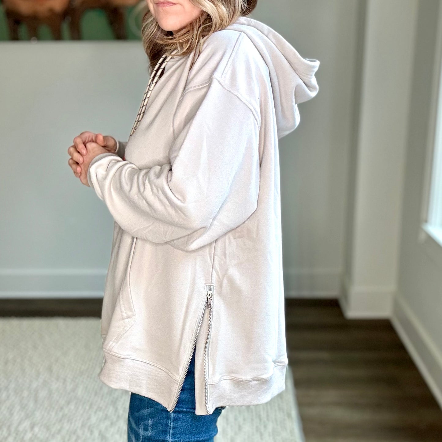 Light grey super soft hooded side zip pullover sweatshirt with front pocket and neon coral tipped drawcord Edit alt text