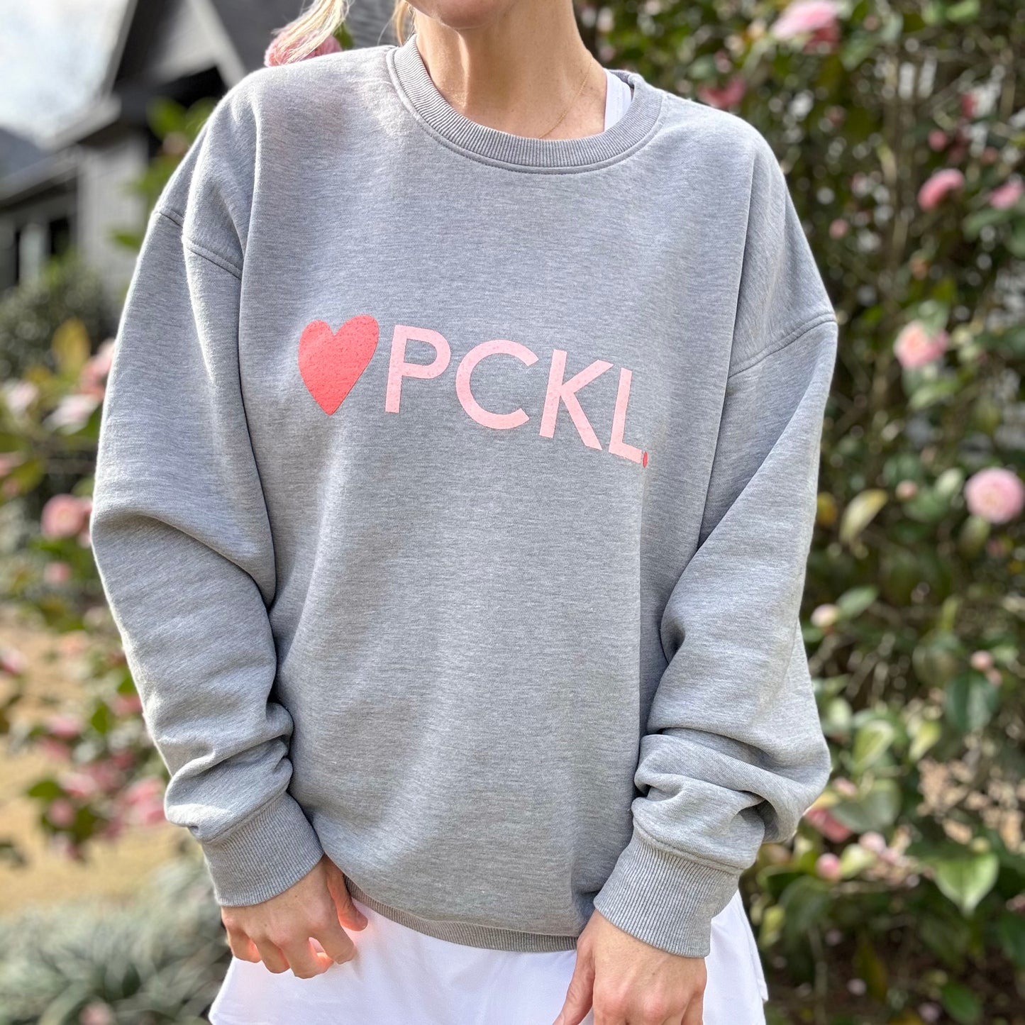 Women's heather gray classic crewneck fleece sweatshirt with pink heart PCKL pickleball screenprint