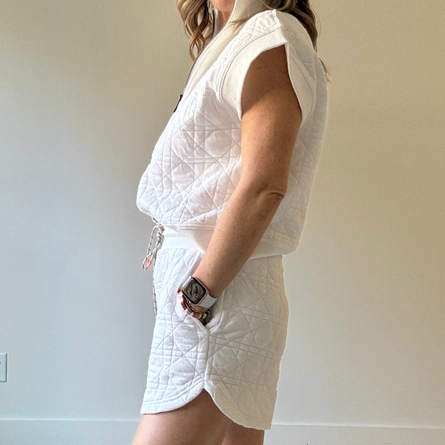 Women's preppy white textured knit short with elastic tie waist, neon coral tipped drawcord, pockets with striped label