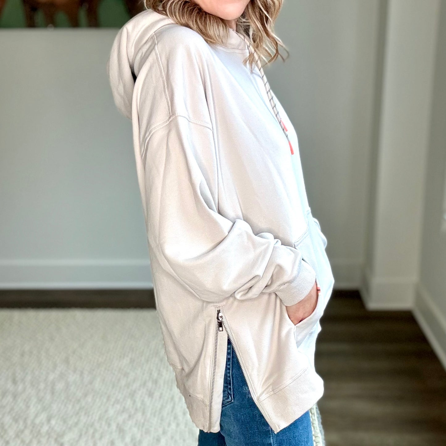 Light grey super soft hooded side zip pullover sweatshirt with front pocket and neon coral tipped drawcord