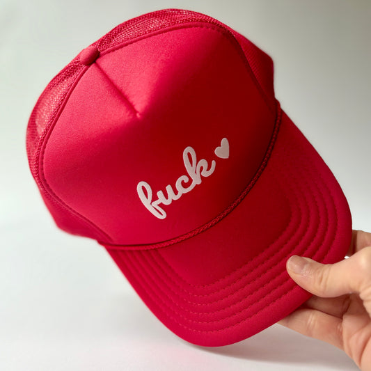 Red mid profile foam trucker hat with fuck heart flocked print