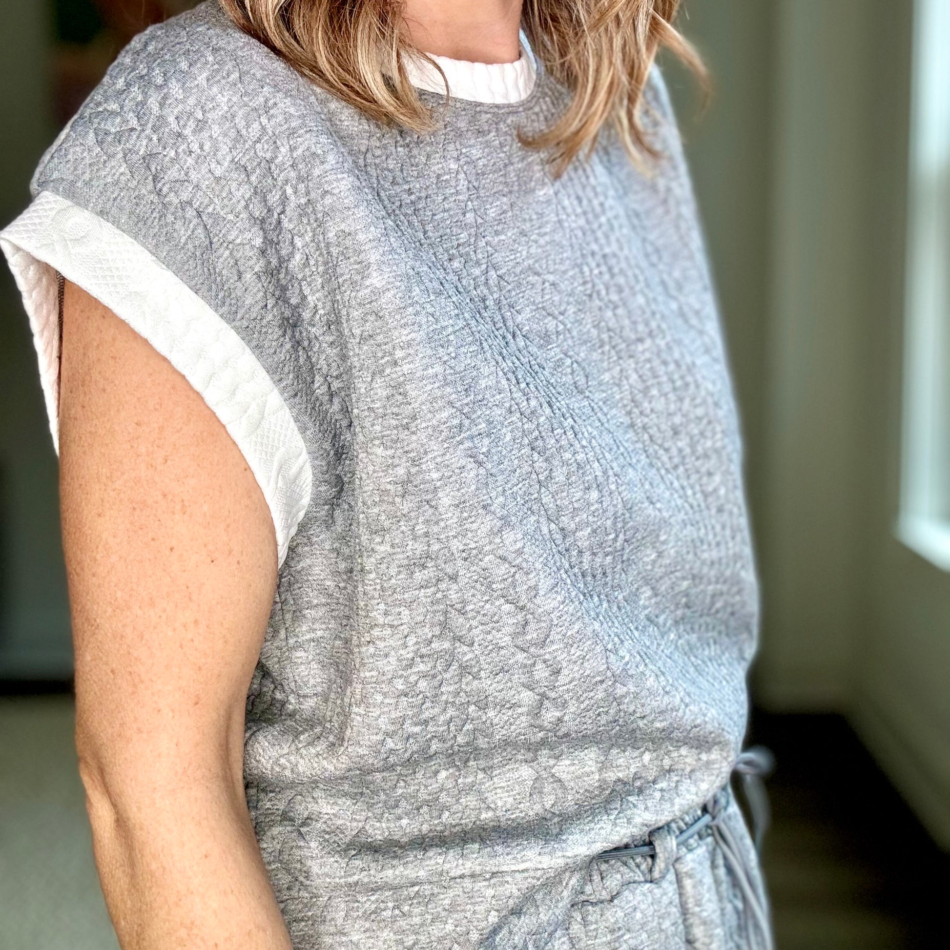 Heather grey cable knit textured cap sleeve top with white tipping at neck and armholes