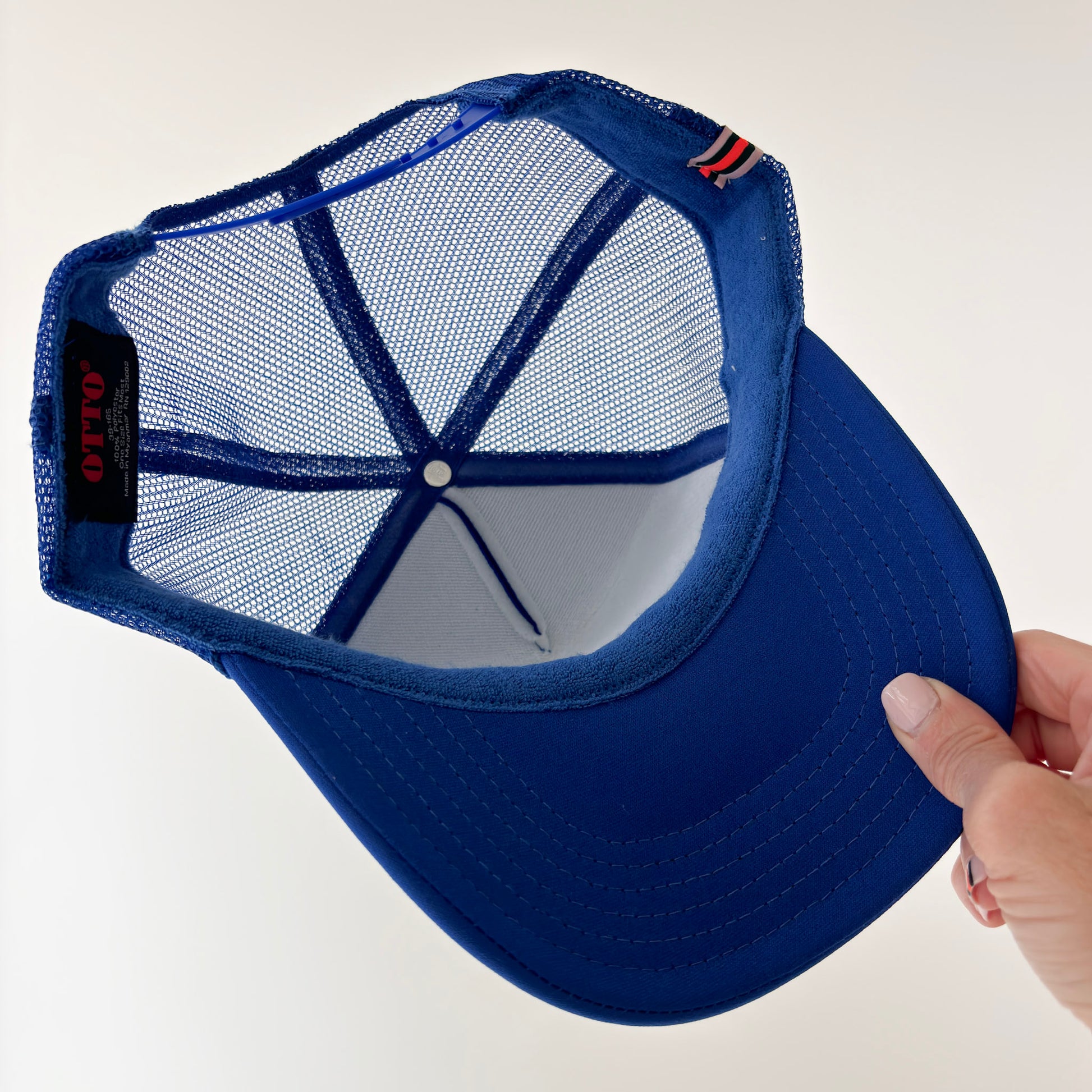 Women's high profile bright blue snap back trucker hat with light pink après lake graphic