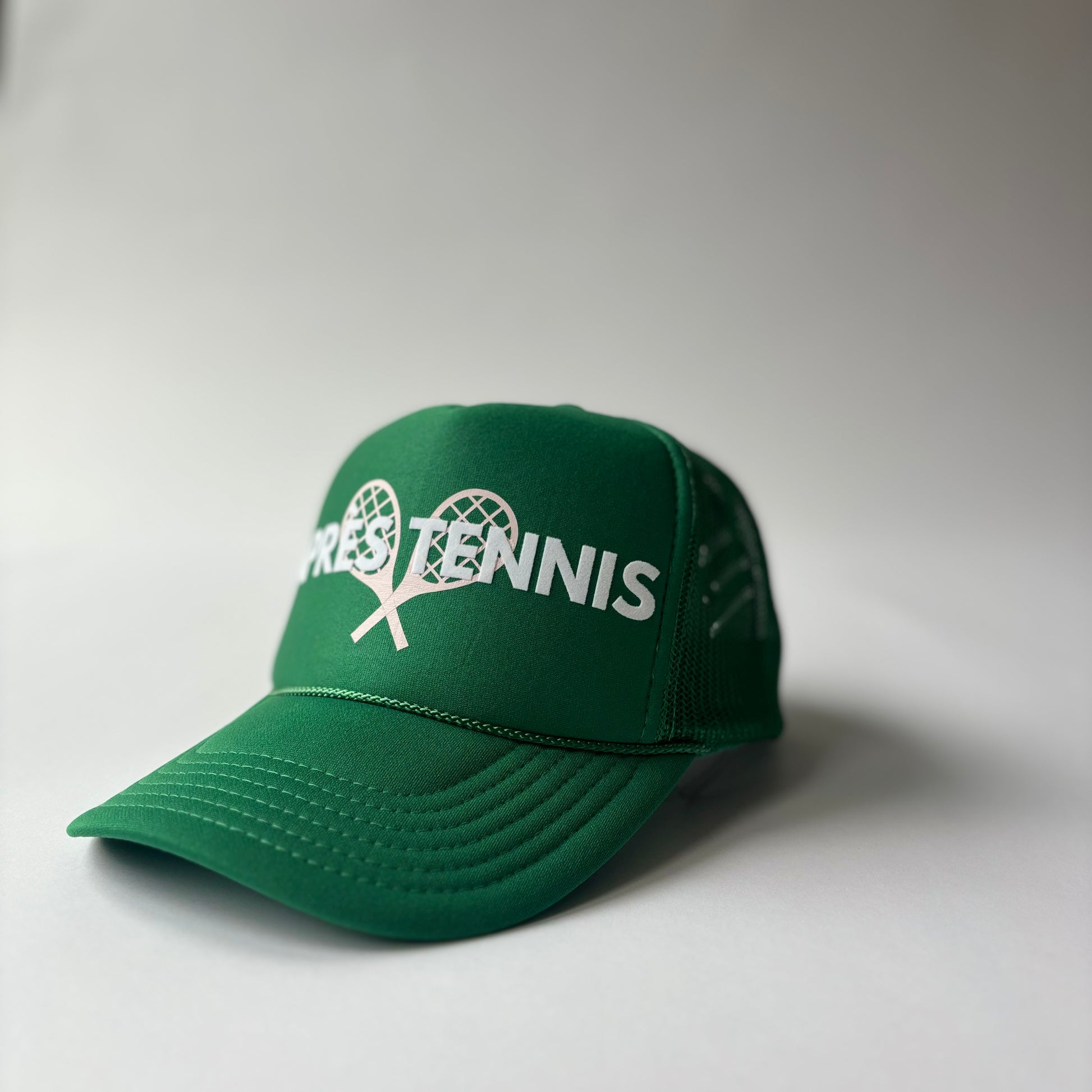 Kelly Green mid profile foam trucker hat with white flocked apres tennis and light pink tennis racket print