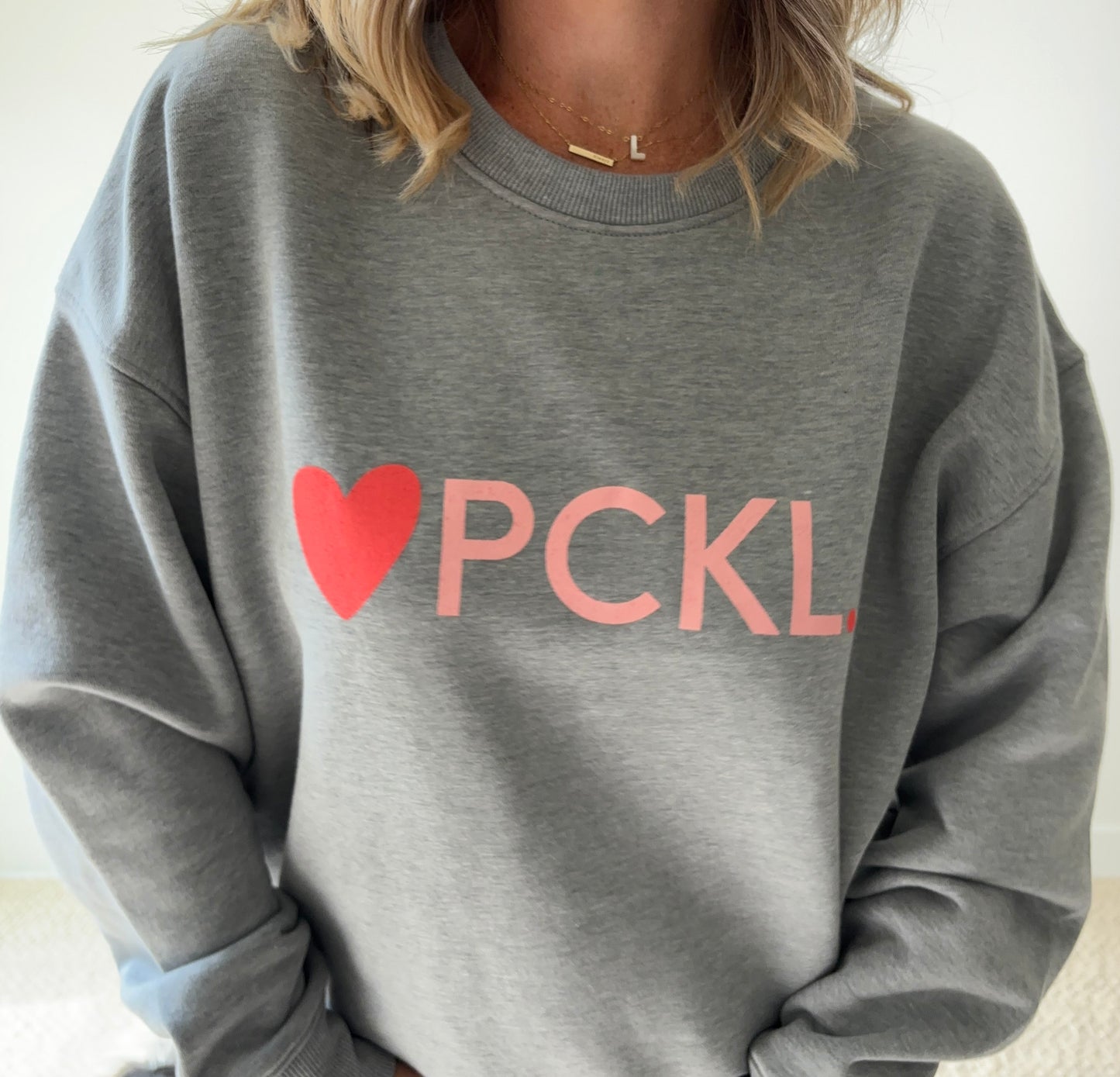 Women's heather gray classic crewneck fleece sweatshirt with pink heart PCKL pickleball screenprint
