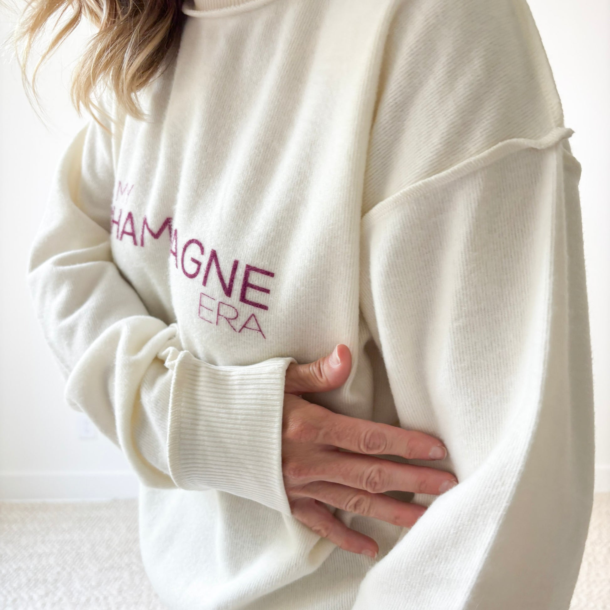 Women's Ivory fuzzy exposed seem crewneck sweatshirt with burgandy In My Champagne Era print
