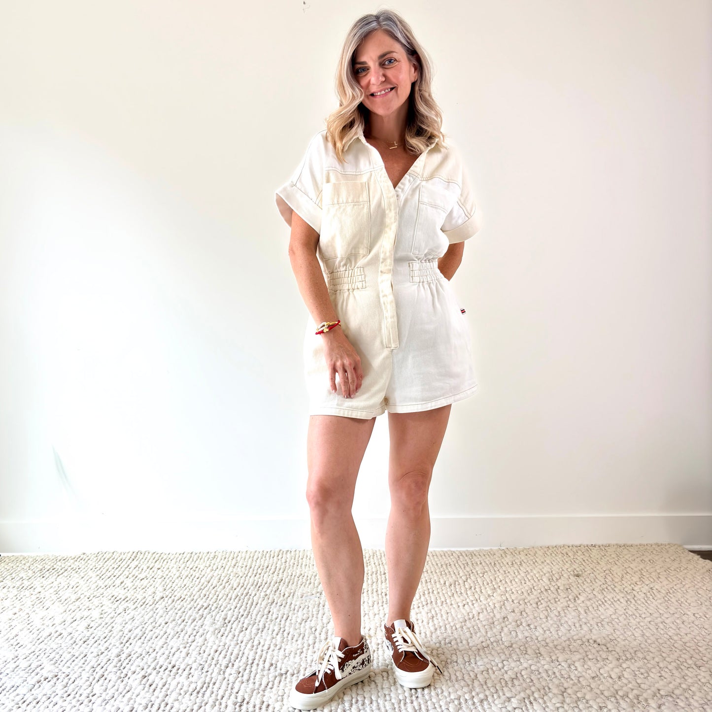 Two tone ivory and white color blocked short romper with pockets and elastic waist