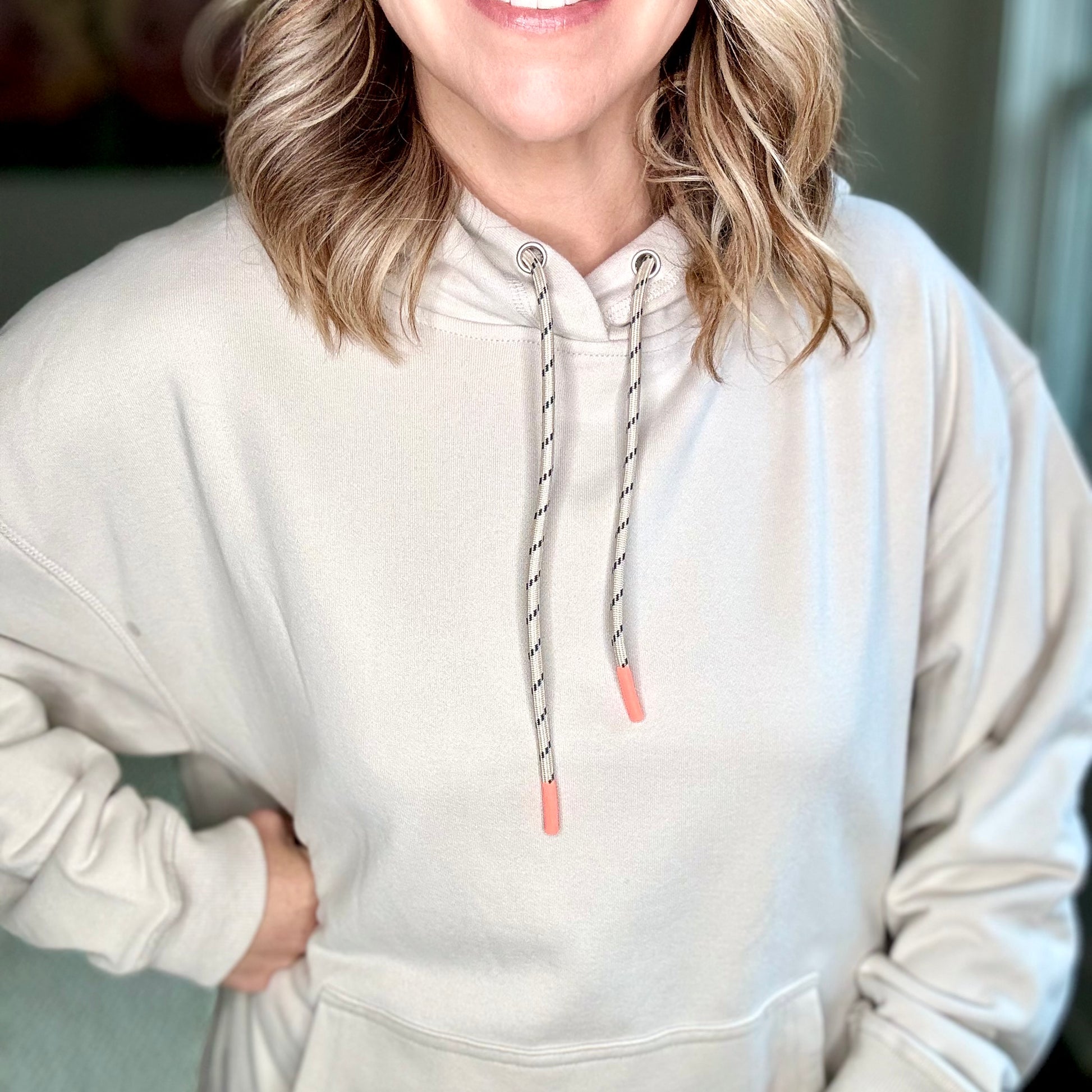Light grey super soft hooded side zip pullover sweatshirt with front pocket and neon coral tipped drawcord  Edit alt text