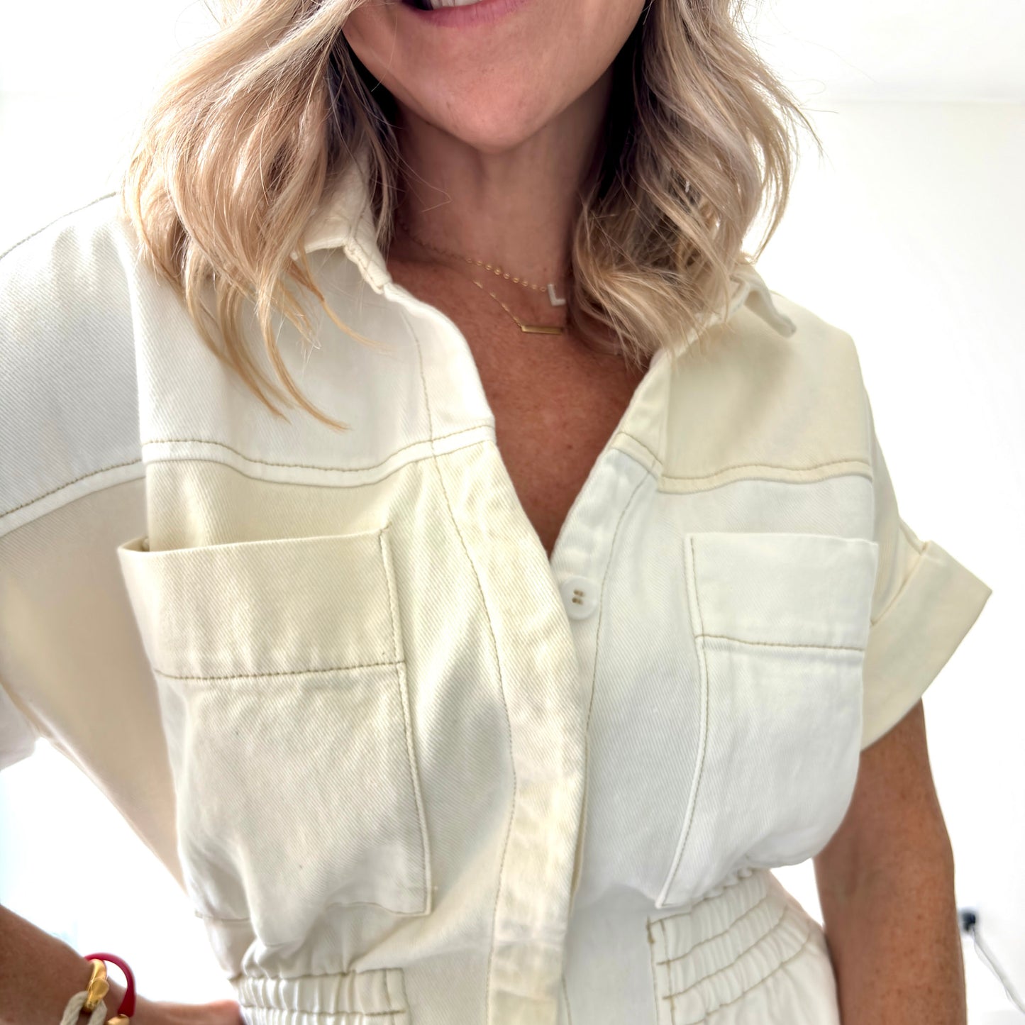 Two tone ivory and white color blocked short romper with pockets and elastic waist