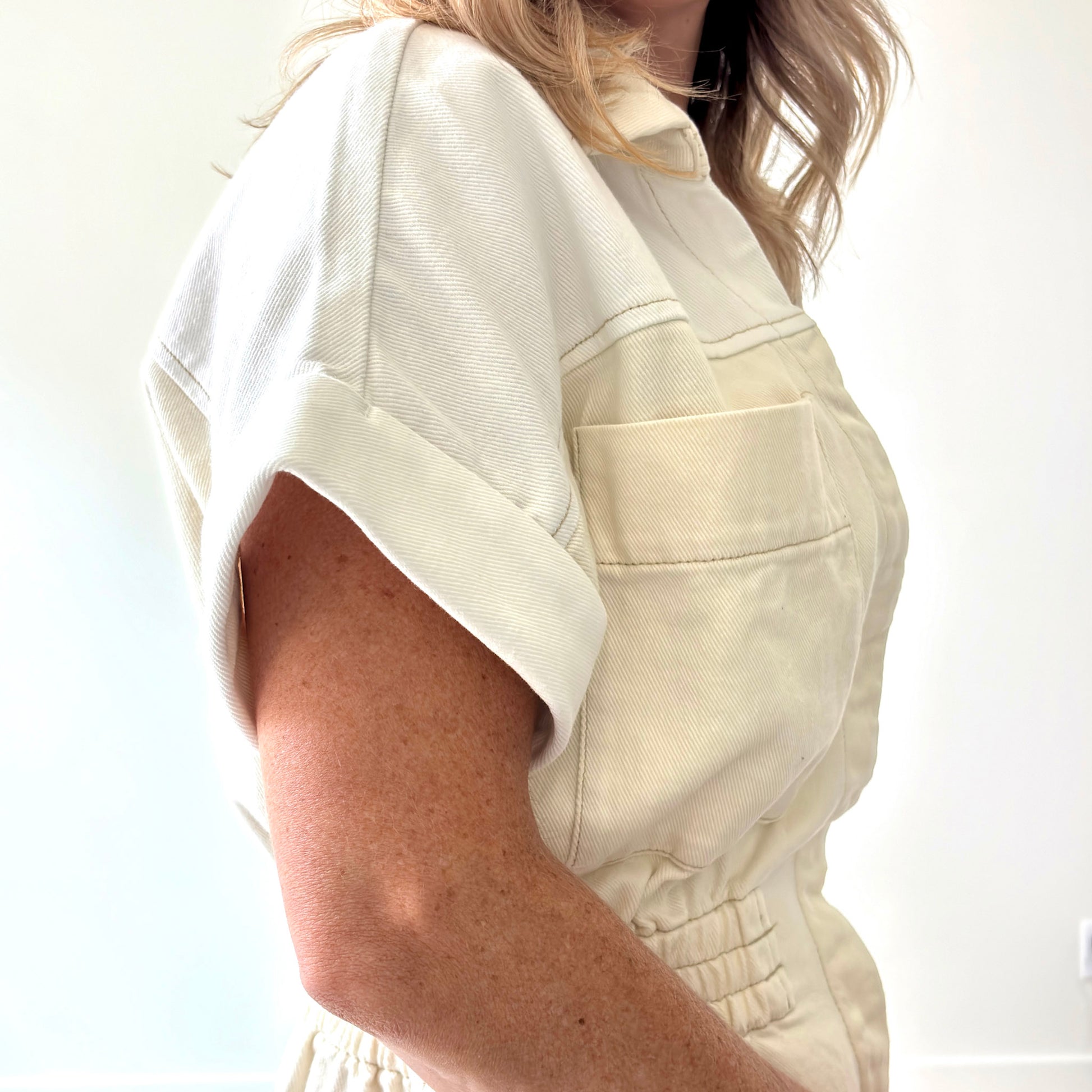 Two tone ivory and white color blocked short romper with pockets and elastic waist