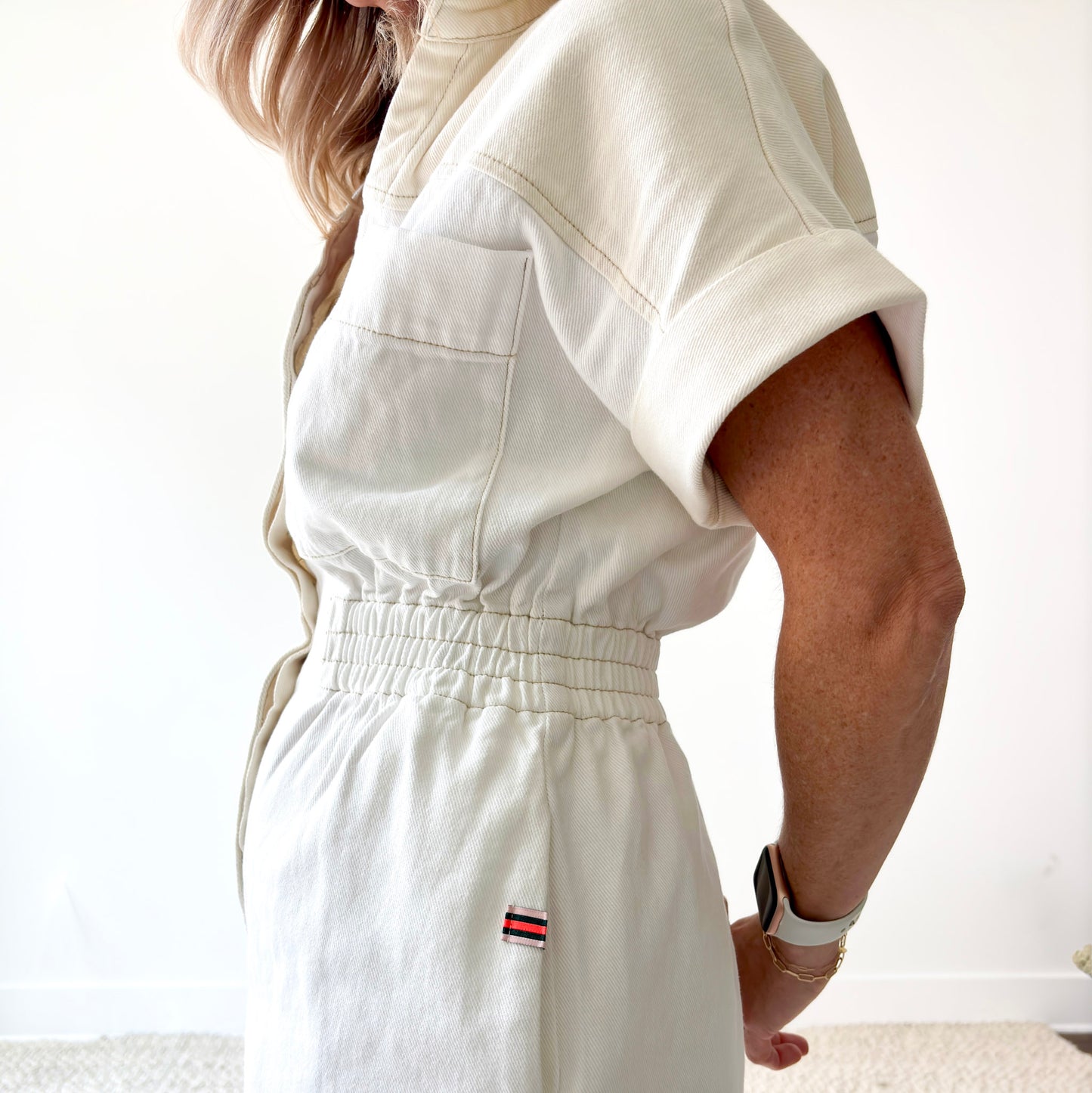Two tone ivory and white color blocked short romper with pockets and elastic waist