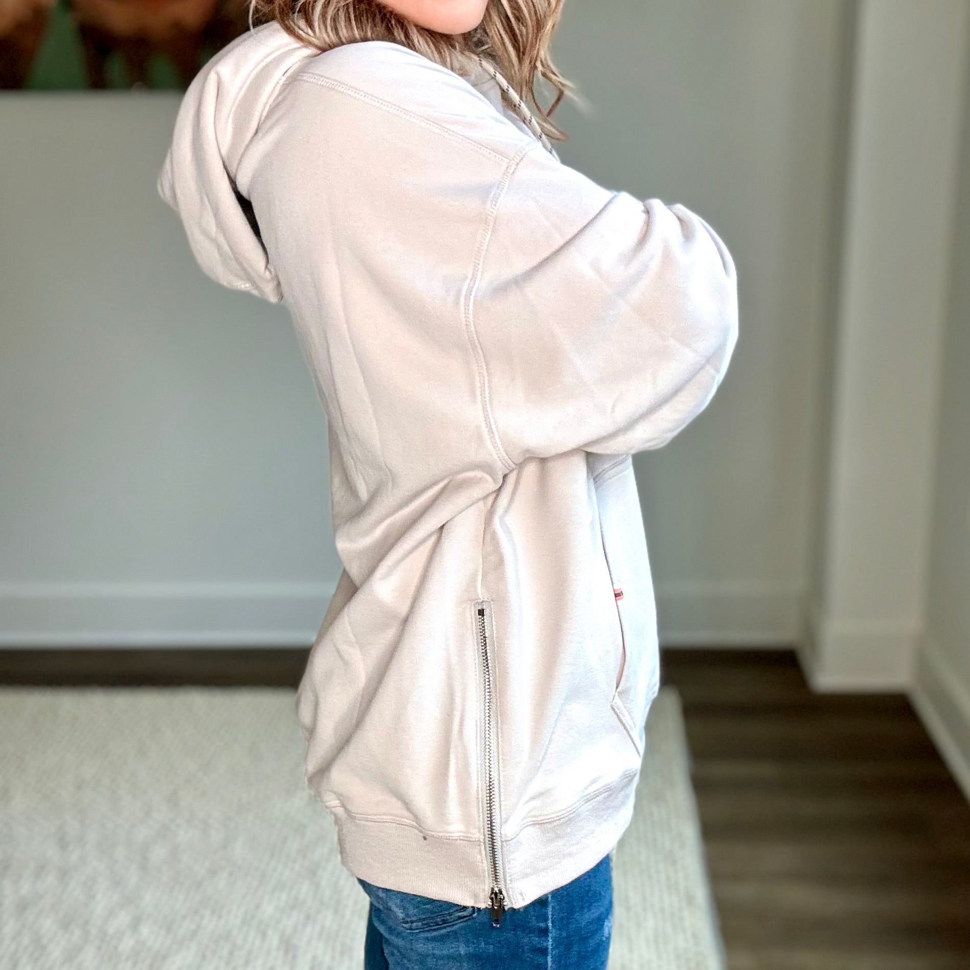 Light grey super soft hooded side zip pullover sweatshirt with front pocket and neon coral tipped drawcord  Edit alt text