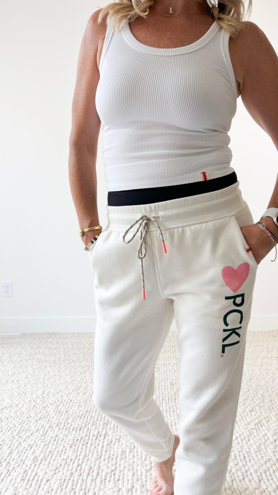 Women's ivory slim fit fleece jogger with pink heart and dark green pckl pickleball print.