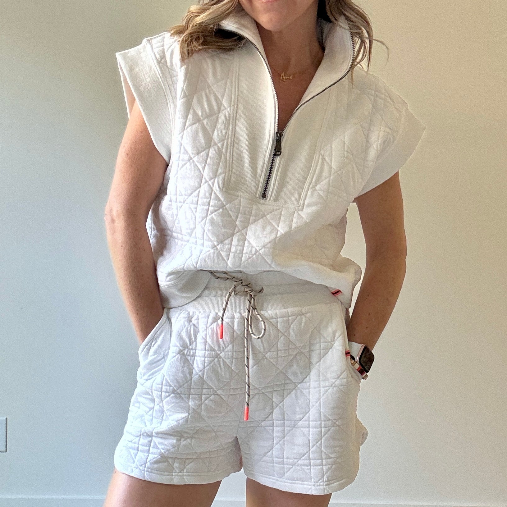 Women's preppy white textured knit short with elastic tie waist, neon coral tipped drawcord, pockets with striped label